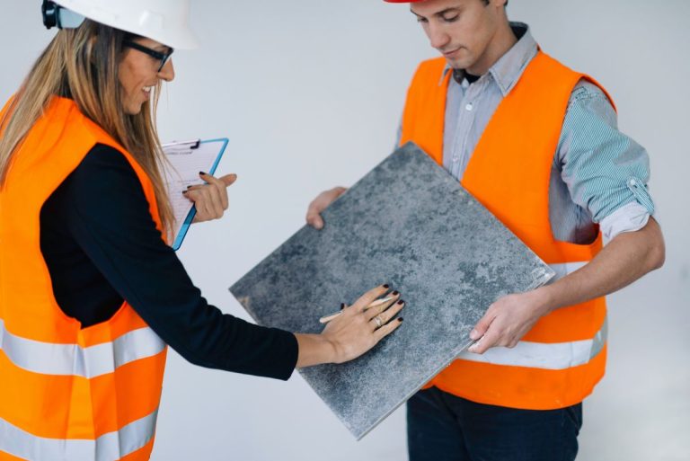 Architects examining tiles on construction site